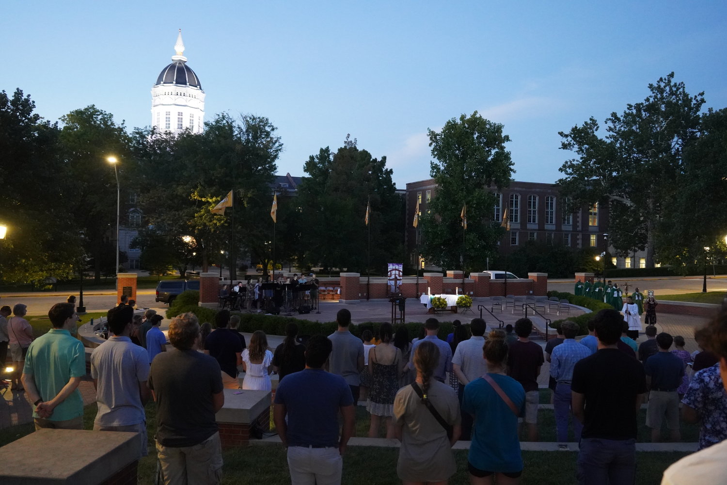 Concelebrating priests process into Traditions Plaza for the Mass on the Quad, a beloved tradition organized by the St. Thomas More Newman Center Parish’s campus ministry department and parishioners.